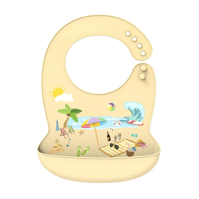 Adjustable cream silicone baby bib with a colorful beach scene print and food-catching pocket.