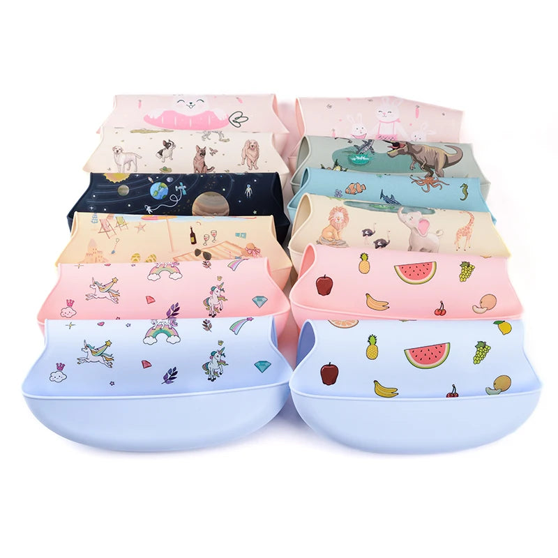 Colorful silicone baby bibs with deep catch-all pockets, featuring various animal and fruit patterns.