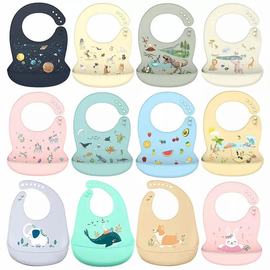 Twelve colorful silicone baby bibs with adjustable neckbands and food-catching pockets, featuring various cute animal and space designs.