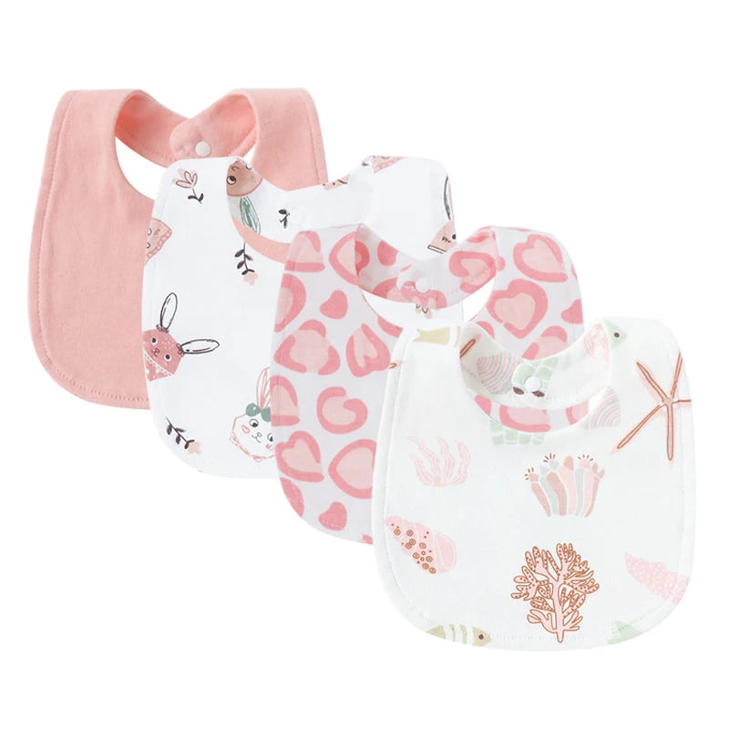 Set of four soft pink and white cotton baby bibs with cartoon animal and coral patterns.