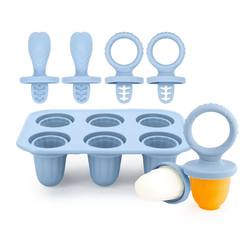 Light blue silicone baby popsicle mold with six cavities and four handles, plus one orange pop.
