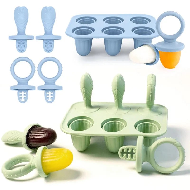 Blue and green silicone baby popsicle molds with handles, some filled with purees.