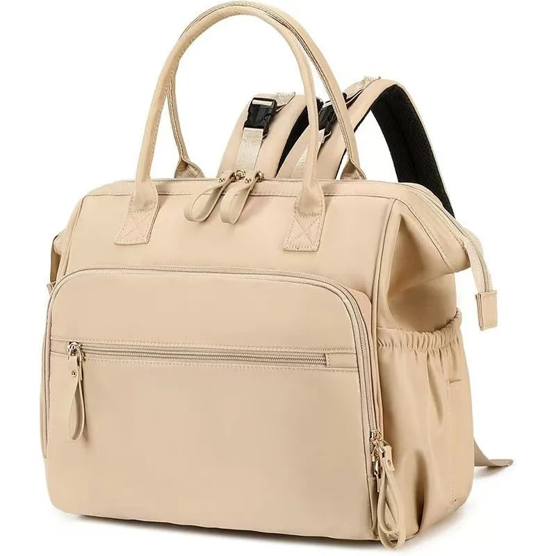 Beige large capacity polyester diaper backpack with multiple zippered pockets and stroller straps.