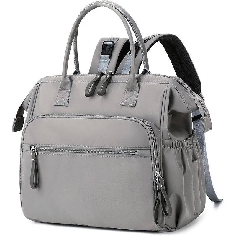 Gray polyester diaper backpack with top handles, front zip pockets, and side pockets.