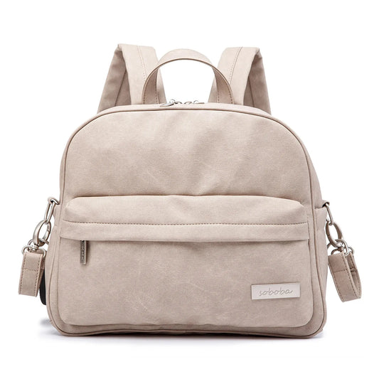 Beige waterproof PU/PVC diaper backpack with front pocket, top handle, and adjustable straps.