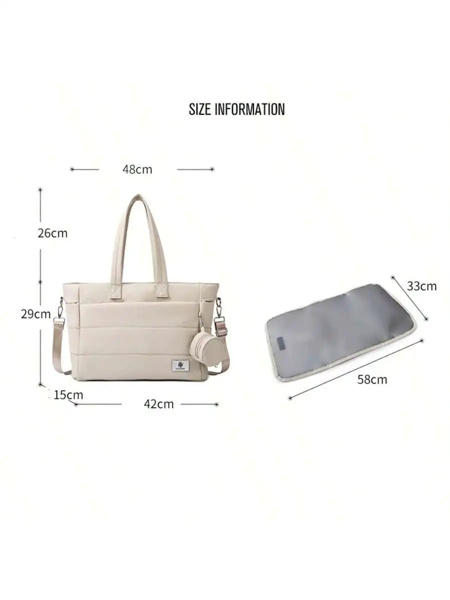 Beige quilted tote diaper bag with shoulder strap, small pouch, and changing pad, showing dimensions.