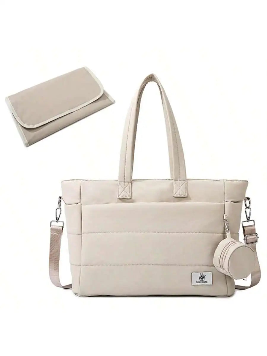 Stylish beige quilted diaper tote bag with shoulder strap, changing pad, and small pouch.