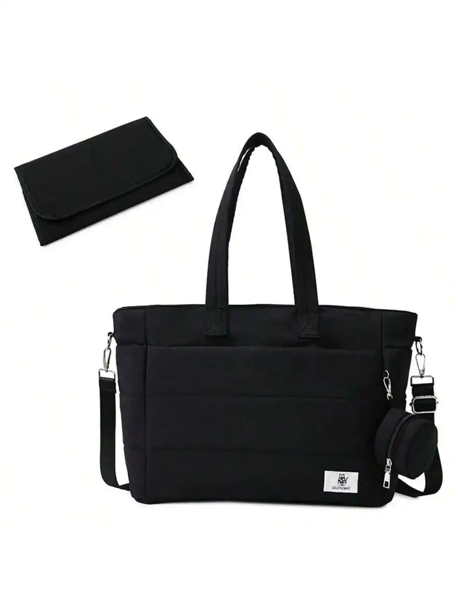 Black quilted diaper tote bag with shoulder strap, small pouch, and changing pad.