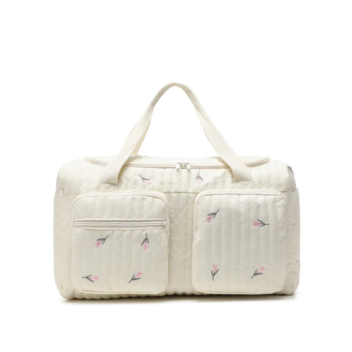 Embroidered cotton diaper bag in cream with pink floral design, zipper closure, and front pockets.