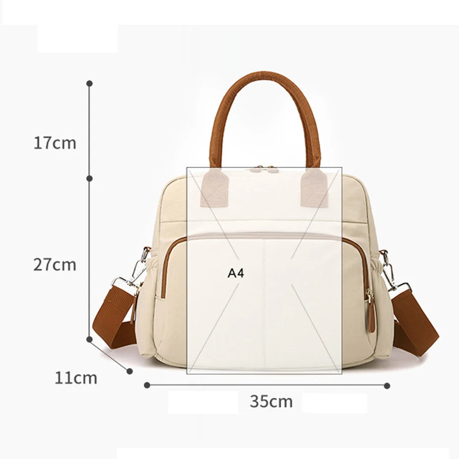 Cream diaper bag with brown handles and shoulder strap, showing dimensions and A4 size comparison.
