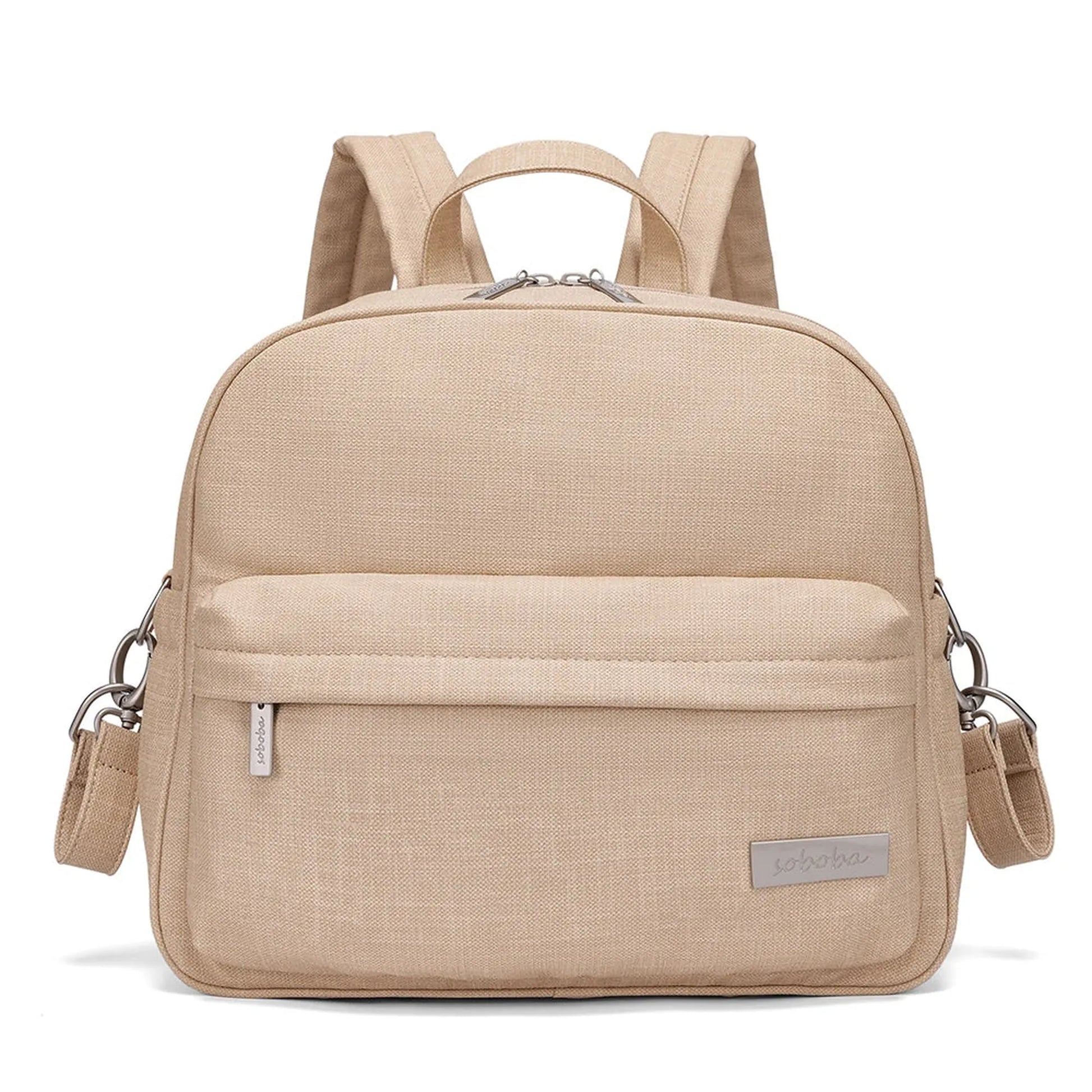Stylish beige diaper backpack with front pocket, top handle, and adjustable straps.