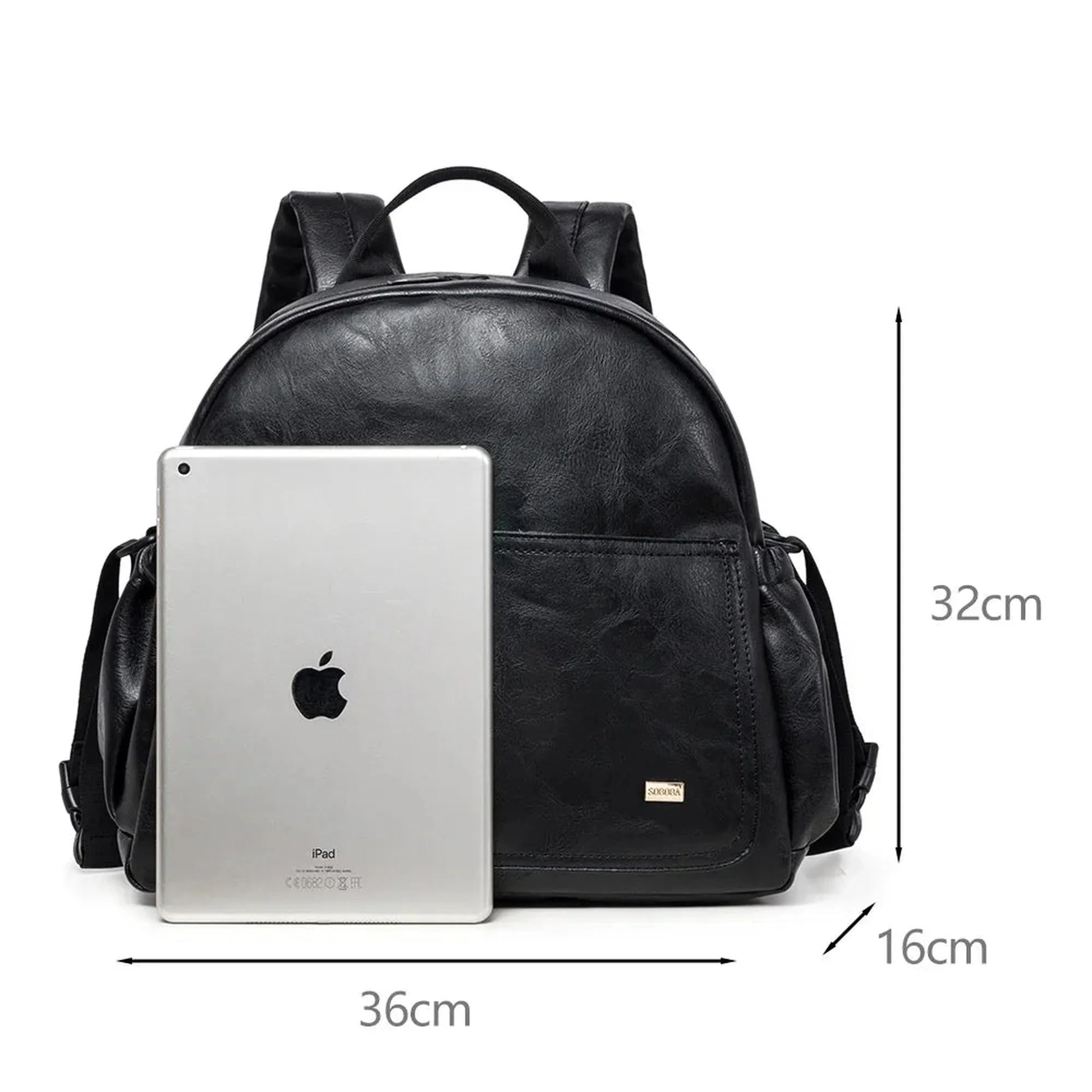 Black PU leather diaper backpack with large capacity, showing 36x32x16cm dimensions next to an iPad.