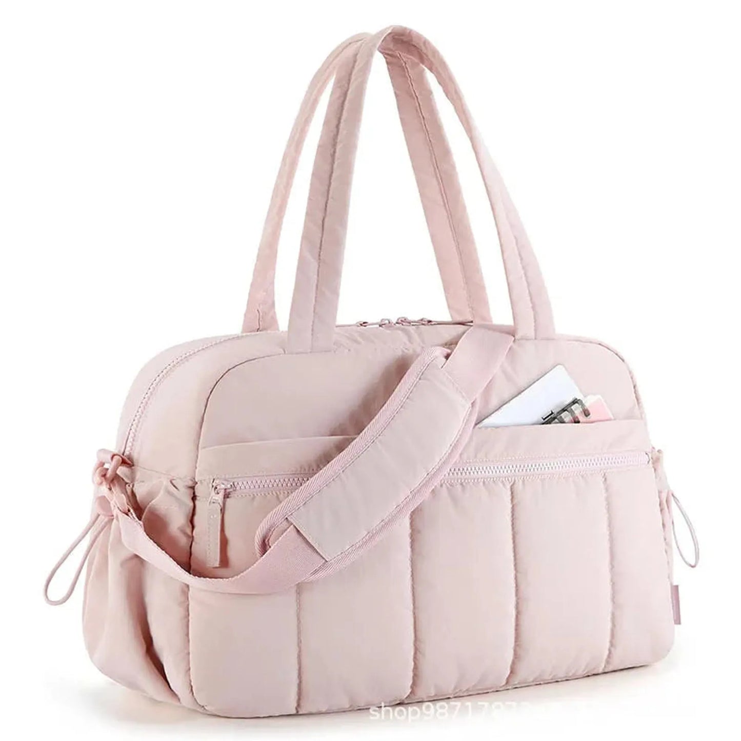 Pink quilted waterproof nylon diaper bag with top handles, shoulder strap, and front pockets.