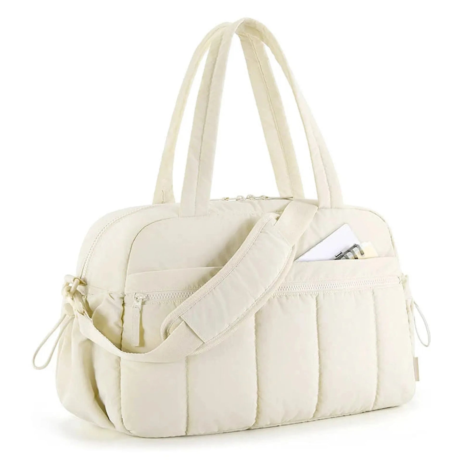 Cream quilted waterproof diaper bag with top handles, shoulder strap, and front pocket.