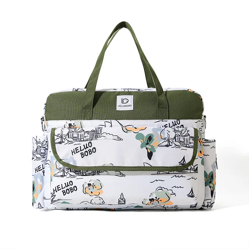 White and olive green Oxford waterproof diaper bag with playful cartoon print and multiple pockets.