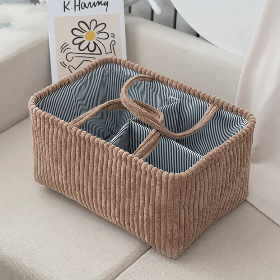 Brown corduroy diaper caddy with striped interior and multiple compartments for baby essentials.