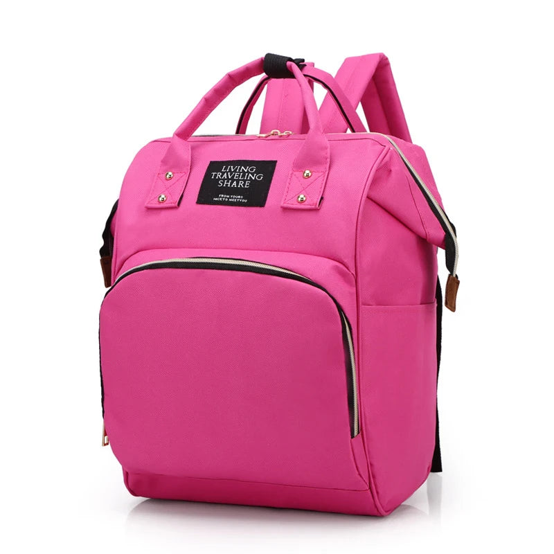 Pink canvas diaper backpack with thermal pocket, top handles, and front zipper.