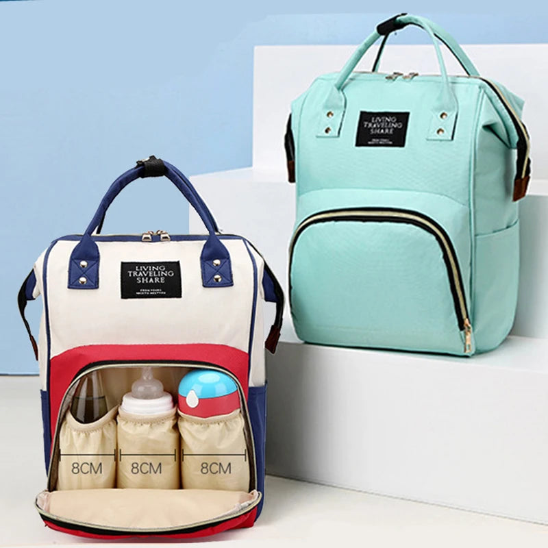 Multifunctional canvas diaper bag in mint green and a red, white, and blue version with a thermal compartment.