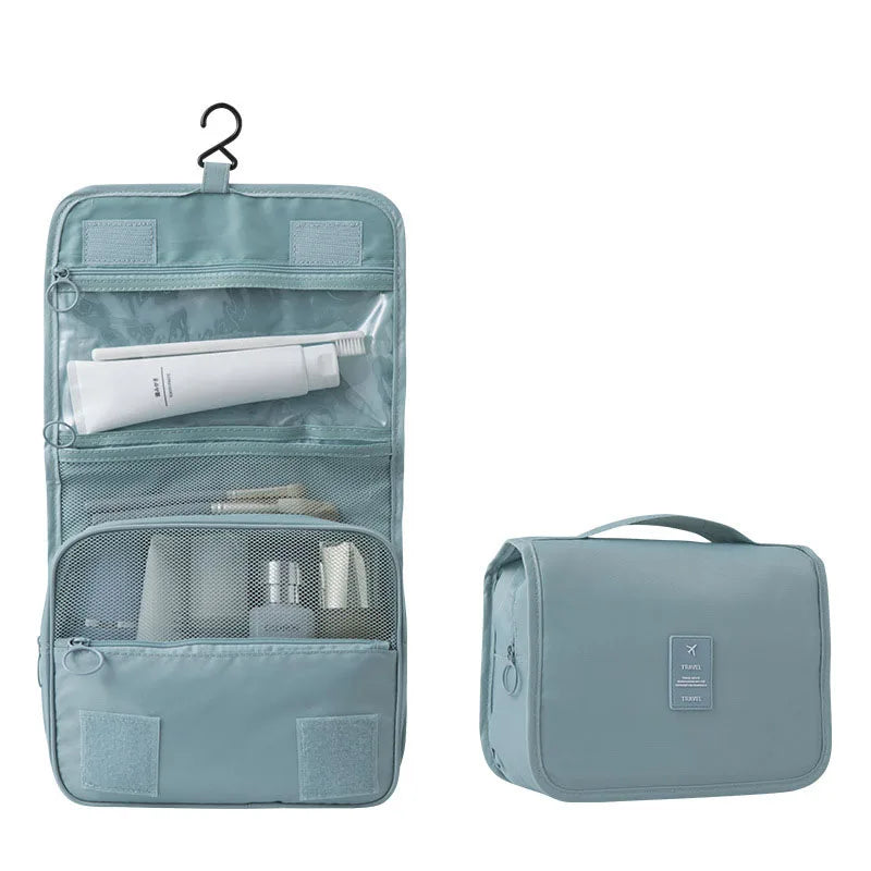 Light blue polyester hanging travel toiletry bag, open with compartments and closed with a handle.