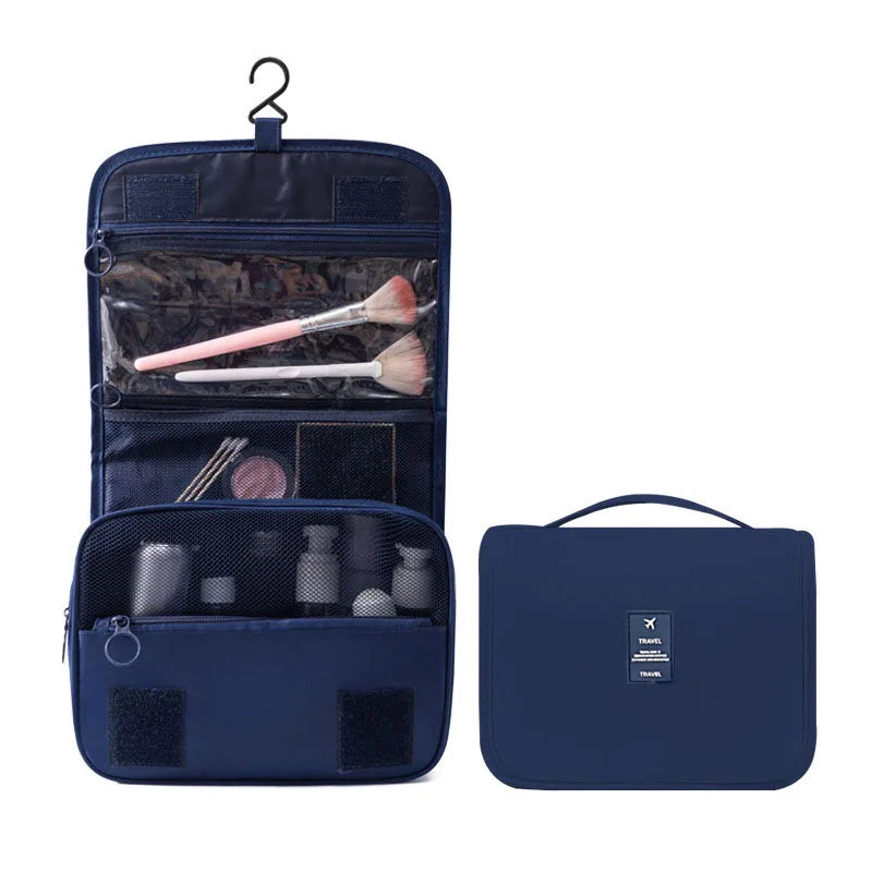 Navy blue hanging travel toiletry bag, open with clear compartments and makeup brushes, next to a closed view.
