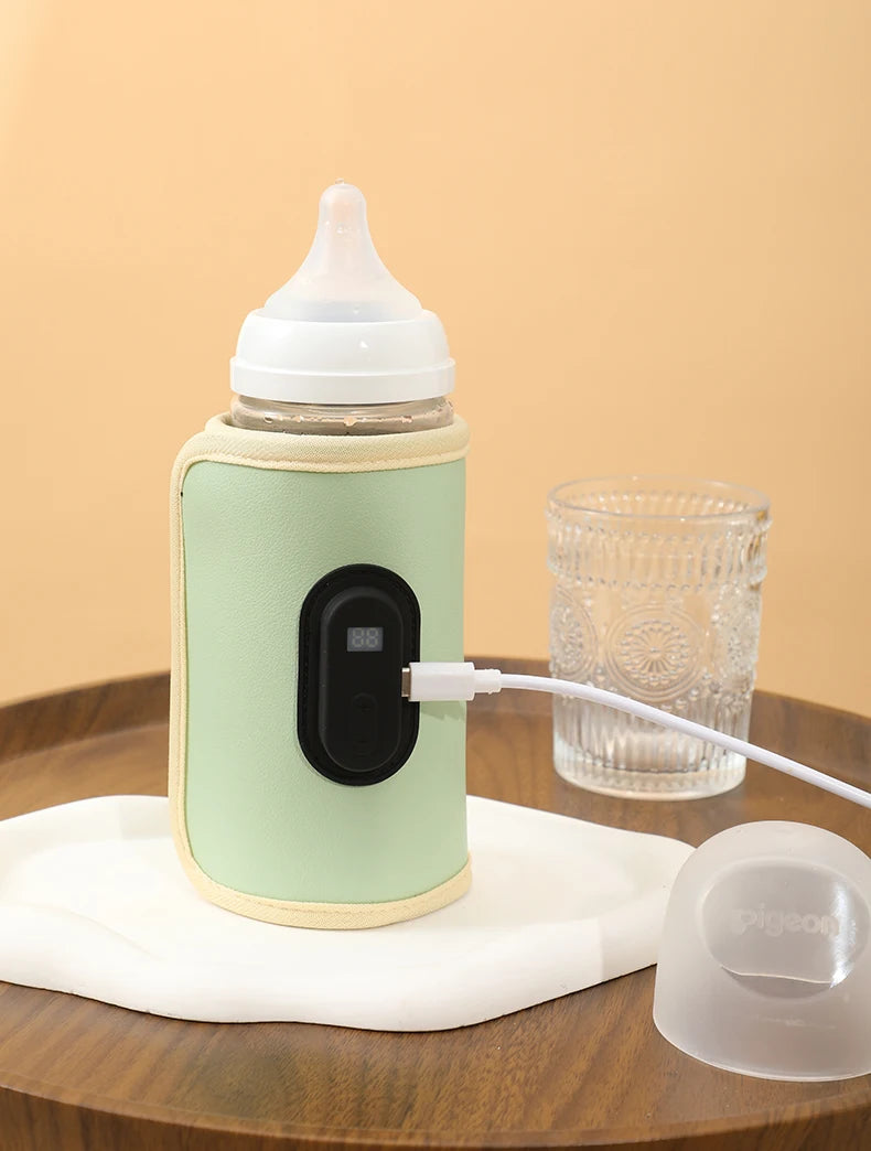 Portable green USB baby bottle warmer with digital display, connected to a white USB-C cable.