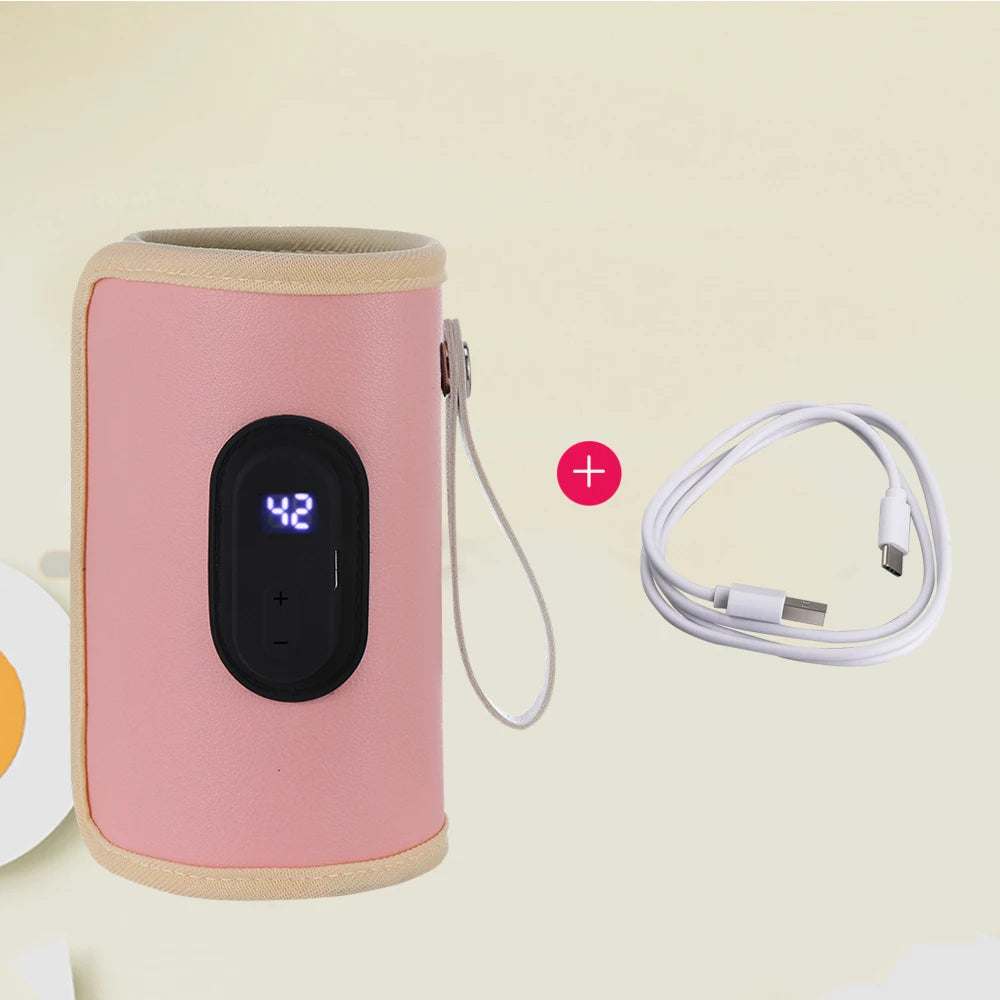 Pink portable USB baby bottle warmer with digital display and white charging cable.